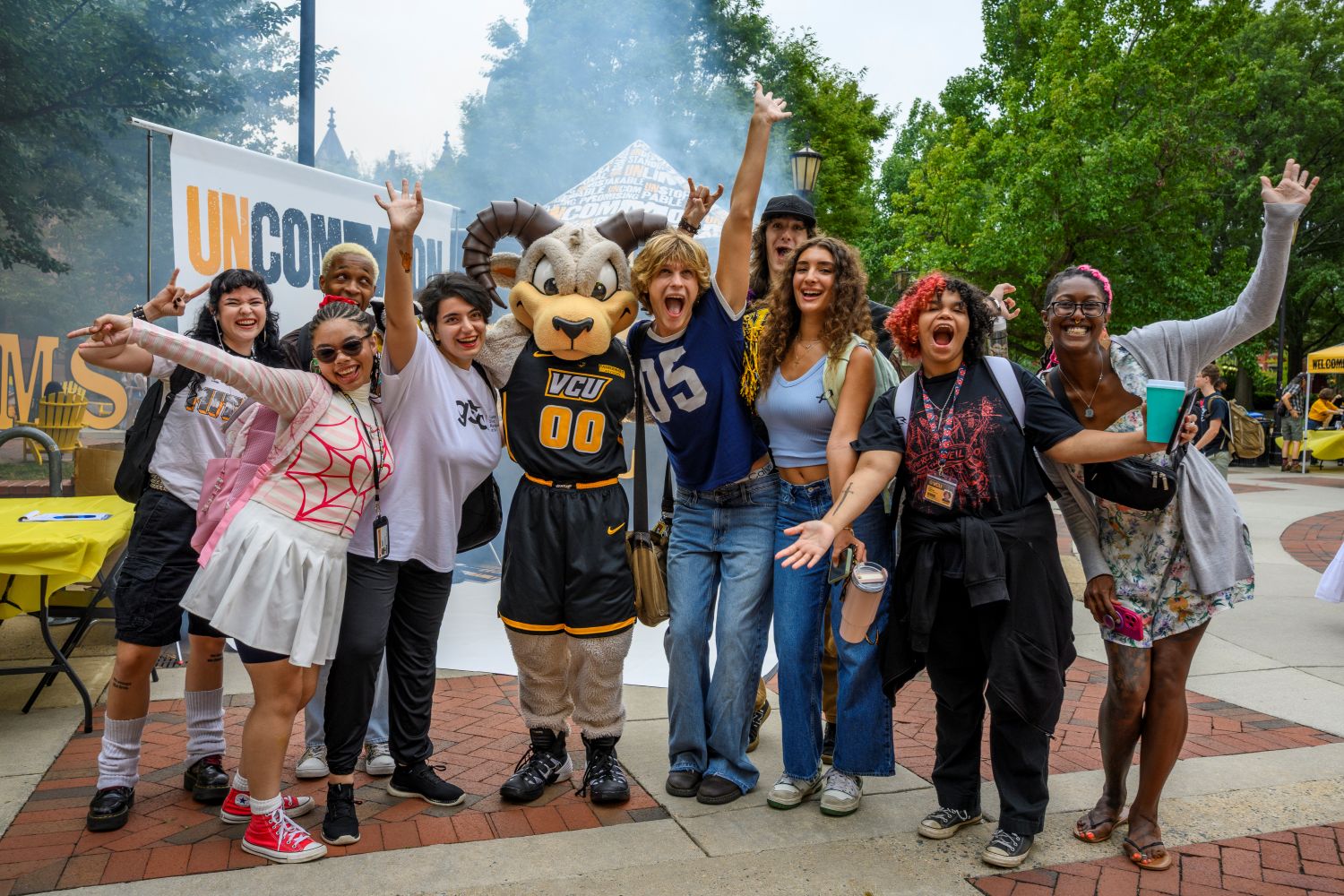 Diverse group of students posing with Rodney the Ram, the VCU mascot